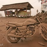 A motorcycle is covered in volcanic ash