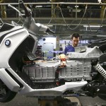 A mechanic assembles a BMW C evolution electric maxi-scooter at the BMW motorcycle plant in Berlin