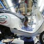 Worker puts the final touch on the 500,000th scooter produced in Vietnam during a ceremony at its factory in Vietnam’s northern Vinh Phuc province, outside Hanoi