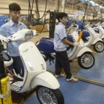 Men work on the assembly line at a Piaggio scooter and motorcycle factory in Vietnam’s northern Vinh Phuc province, outside Hanoi
