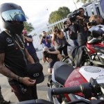 Mercedes Formula One driver Lewis Hamilton of Britain arrives on a motorbike during the Italy F1 Grand Prix in Monza