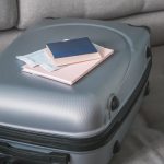 Travel. Online travel plans with Covid passport and Covid test. Traveling after quarantine, lockdown, covid 19. Staycation.local travel new normal.Girl packs baggage in suitcase and travel documents